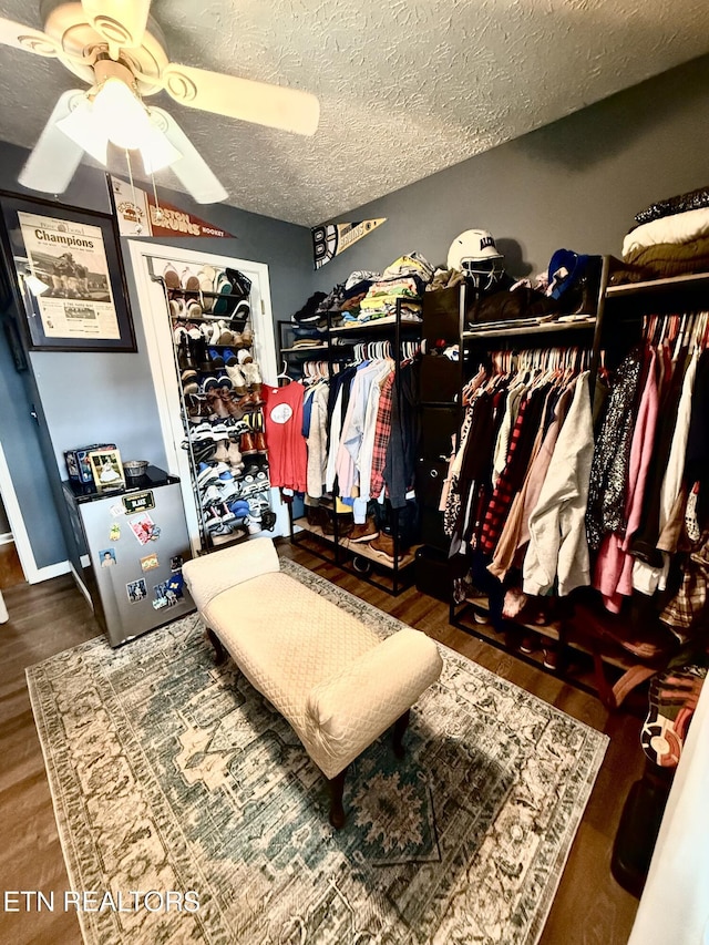 spacious closet featuring wood finished floors and a ceiling fan