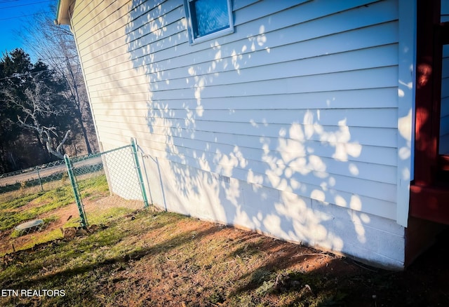 view of side of property featuring fence