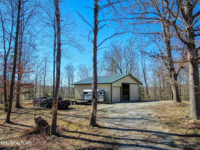 view of outbuilding with driveway and an outbuilding