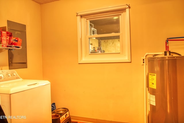 clothes washing area featuring water heater, laundry area, and washer / dryer