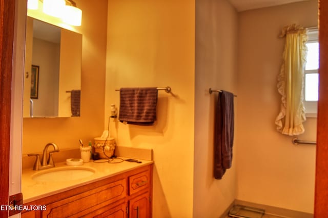 bathroom with vanity and baseboards