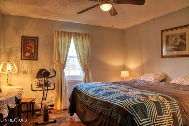 bedroom with carpet floors, a ceiling fan, and a textured ceiling