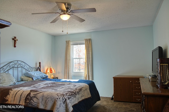 bedroom with dark carpet, a textured ceiling, and ceiling fan