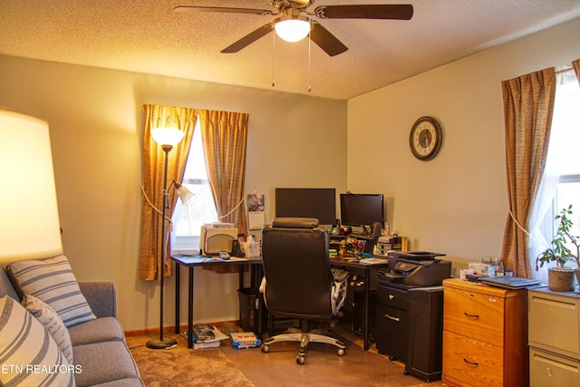 office area with ceiling fan, a textured ceiling, and baseboards