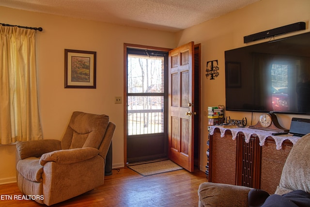 entrance foyer with a textured ceiling and wood finished floors