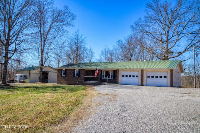 single story home with metal roof, a garage, driveway, crawl space, and a front yard