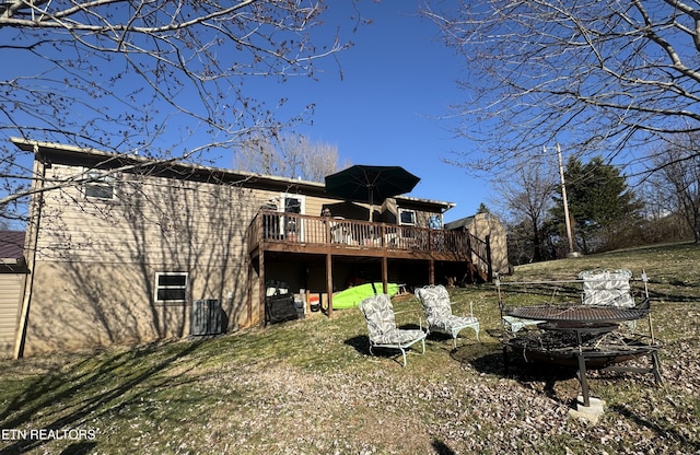 rear view of property featuring a deck