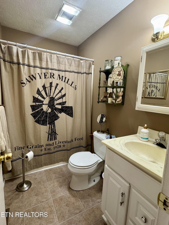 bathroom featuring visible vents, toilet, tile patterned flooring, a textured ceiling, and vanity