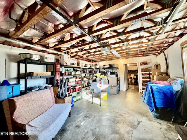 garage with concrete block wall and a garage door opener