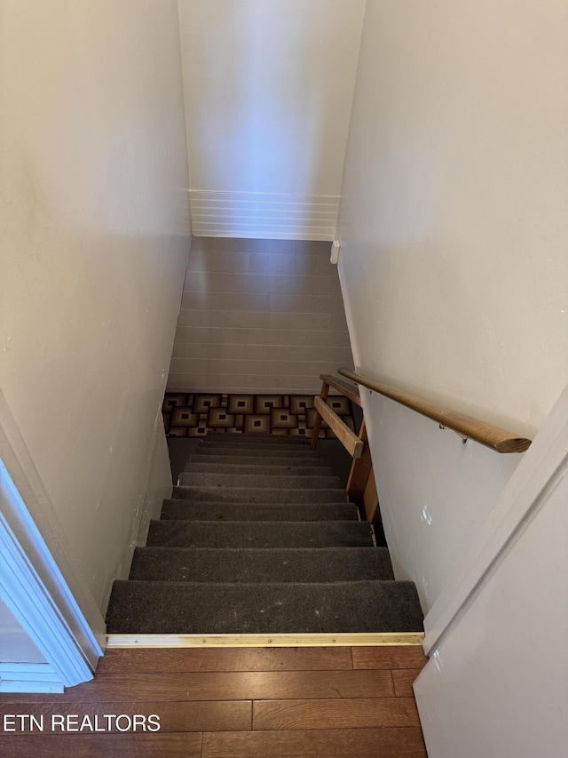 stairs featuring hardwood / wood-style flooring