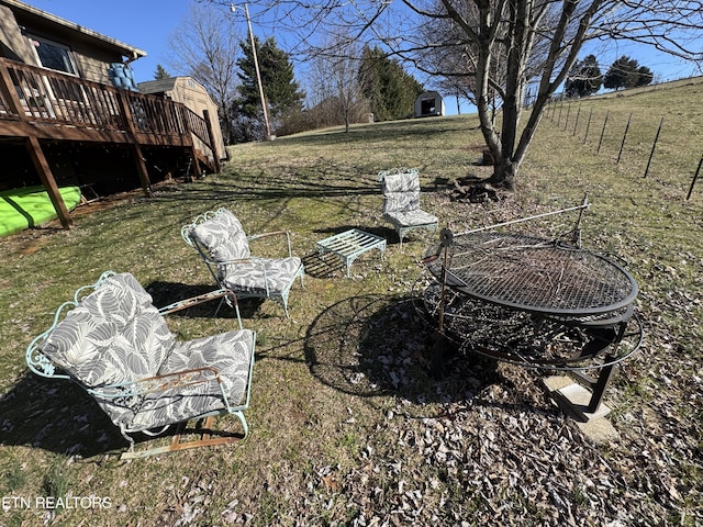 view of yard featuring a fire pit and a wooden deck