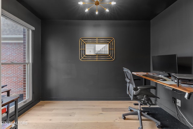 office with light wood-type flooring and baseboards