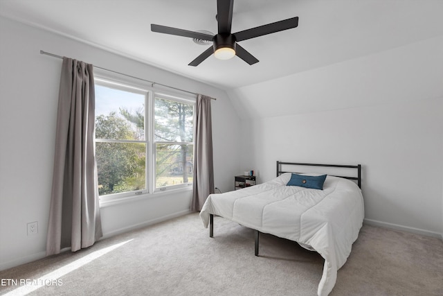 bedroom with lofted ceiling, ceiling fan, carpet flooring, and baseboards