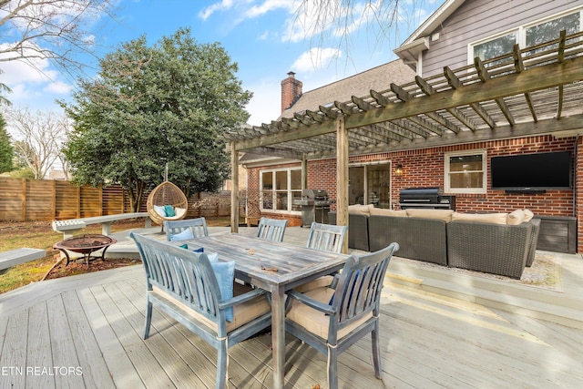 wooden deck featuring fence, outdoor dining area, a pergola, and an outdoor living space with a fire pit