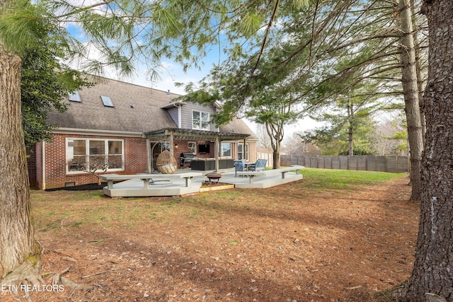 rear view of house featuring roof with shingles, brick siding, crawl space, fence, and a pergola