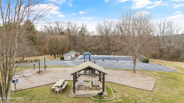 view of community featuring an outbuilding and a yard