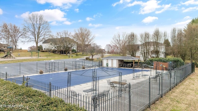 view of pool featuring an outbuilding, playground community, a lawn, a patio area, and fence