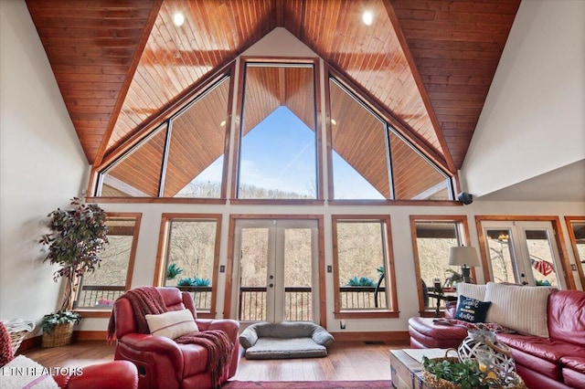 living room featuring plenty of natural light, wood finished floors, and french doors