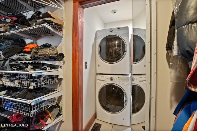 clothes washing area with laundry area and stacked washing maching and dryer