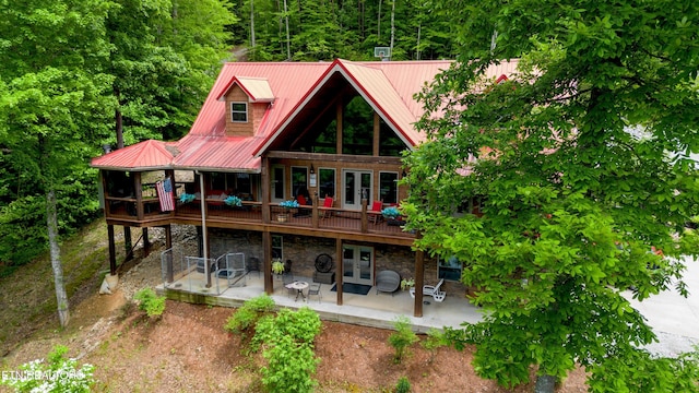 715 Landmark Rd, Jacksboro, TN 37757 - back of house featuring a patio, french doors, a wooden deck, metal roof, and stone siding