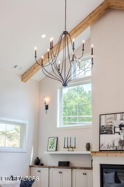 room details with a glass covered fireplace and visible vents