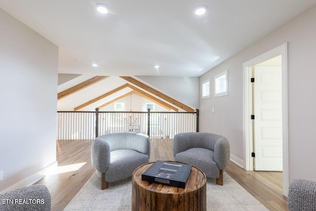 sitting room with light wood-style flooring, vaulted ceiling, and recessed lighting