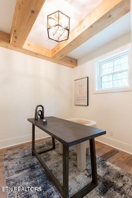 office space featuring wood finished floors, beam ceiling, and baseboards