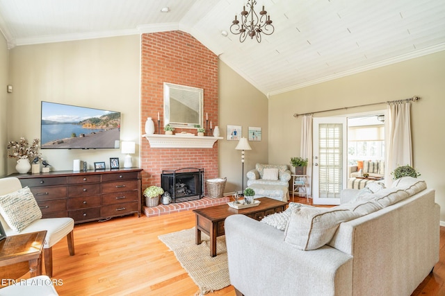 living area with light wood finished floors, a brick fireplace, high vaulted ceiling, and crown molding