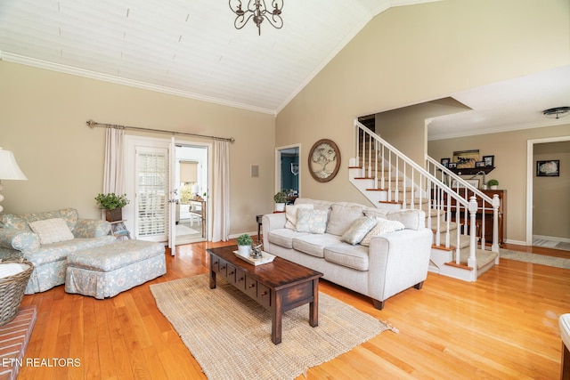 living room with crown molding, stairway, light wood-style floors, and baseboards