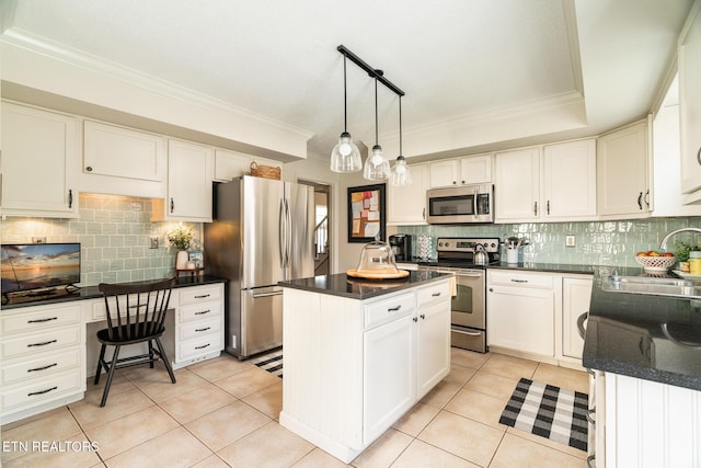 kitchen with a sink, stainless steel appliances, light tile patterned floors, and built in study area