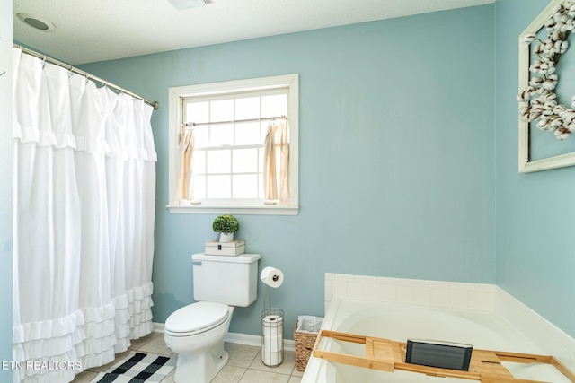 bathroom with tile patterned flooring, toilet, a bath, and baseboards