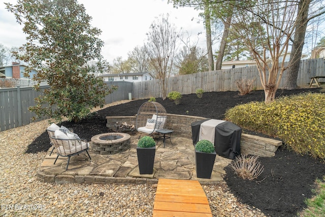 view of patio with a grill, a fire pit, and a fenced backyard