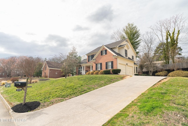 traditional home featuring fence, driveway, a front lawn, a garage, and brick siding