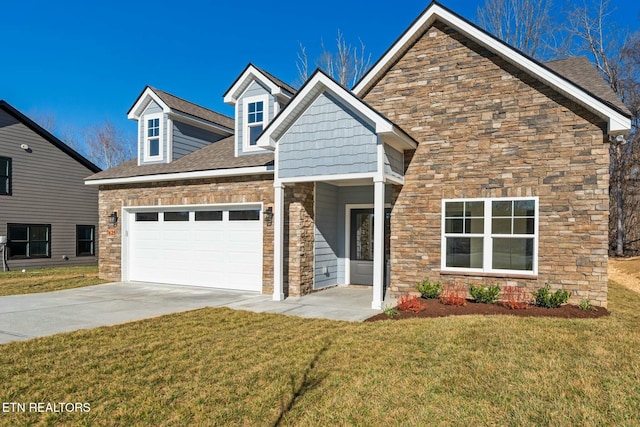 view of front facade with roof with shingles, concrete driveway, a front yard, a garage, and stone siding