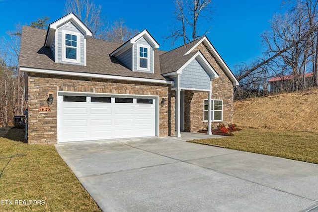 view of front of home with central AC unit, an attached garage, a shingled roof, driveway, and a front lawn