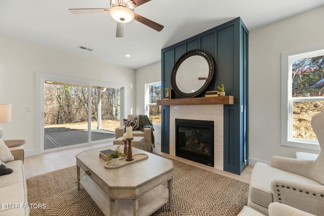 living room featuring a fireplace, recessed lighting, visible vents, a ceiling fan, and baseboards