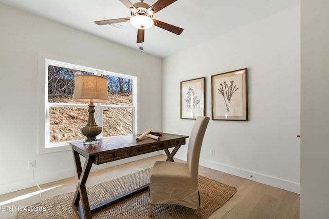 office with a ceiling fan, plenty of natural light, baseboards, and wood finished floors