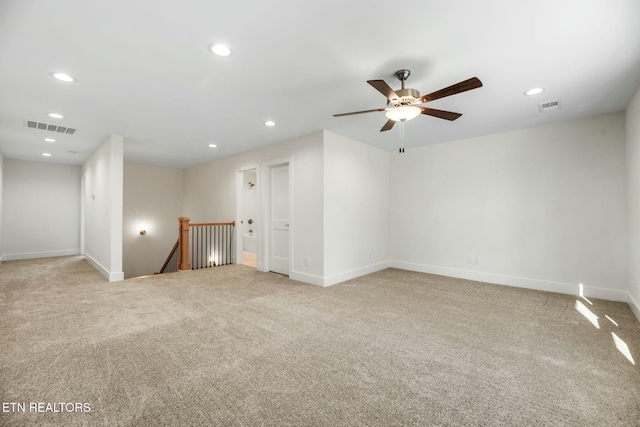 spare room featuring recessed lighting, visible vents, and light carpet