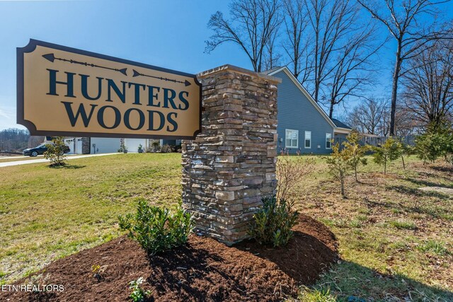 community sign featuring a yard