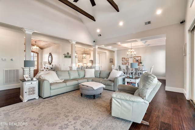 living area featuring beamed ceiling, visible vents, and ornate columns