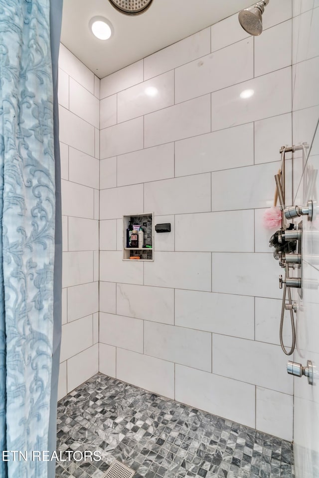 bathroom with tiled shower