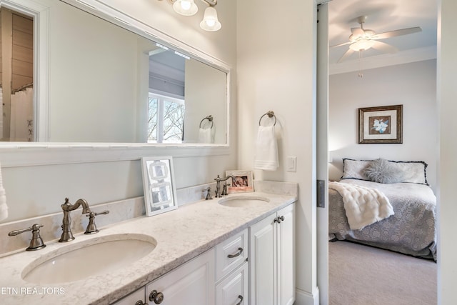 bathroom featuring double vanity, crown molding, a sink, and ensuite bathroom