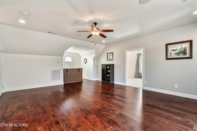 unfurnished living room featuring a ceiling fan, visible vents, vaulted ceiling, and wood finished floors