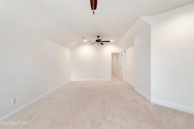 bonus room with light carpet, ceiling fan, vaulted ceiling, and baseboards