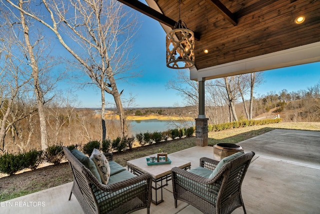 view of patio / terrace featuring a water view and an outdoor living space