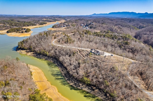 aerial view featuring a water view and a forest view