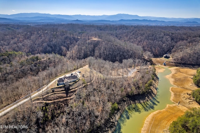 aerial view featuring a mountain view and a wooded view