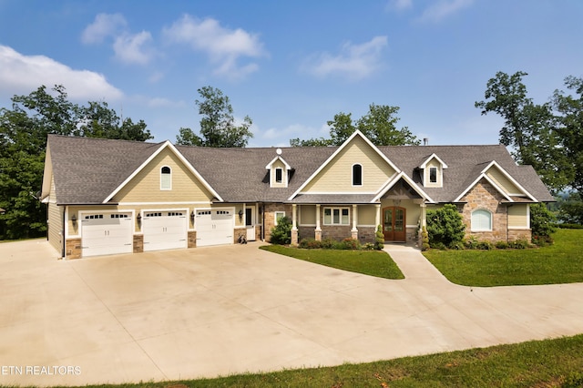 2356 Coaster Way, Sevierville, TN 37876 - craftsman-style home featuring stone siding, french doors, driveway, and a front lawn