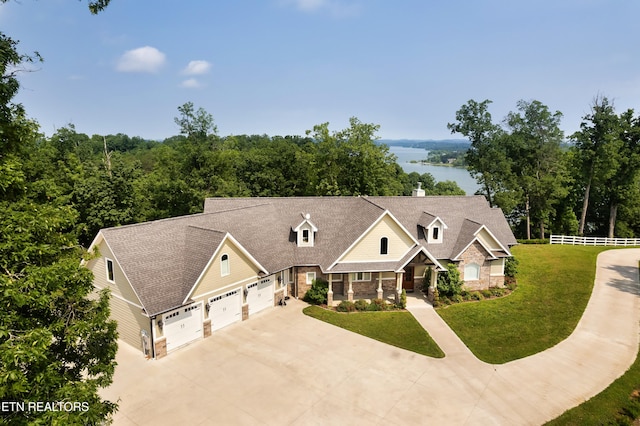 2356 Coaster Way, Sevierville, TN 37876 - view of front of property featuring driveway, stone siding, roof with shingles, an attached garage, and a chimney