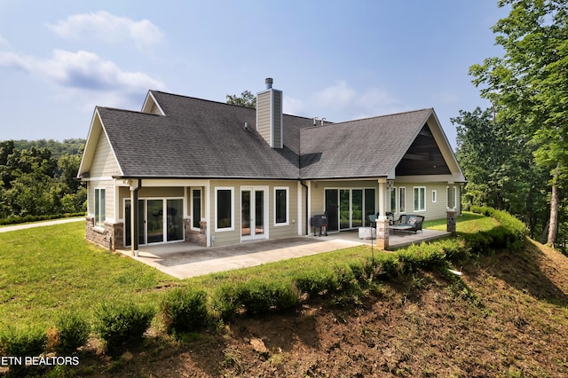 2356 Coaster Way, Sevierville, TN 37876 - rear view of house featuring a chimney, a lawn, a patio area, and roof with shingles